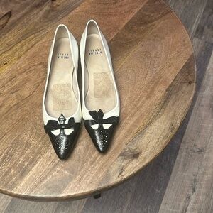 White and black flats with a bow patent leather